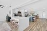 kitchen peninsula with seating off sunroom