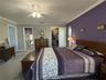 This primary suite is spacious and offers a walk-in closet and beautifully updated ensuite bathroom