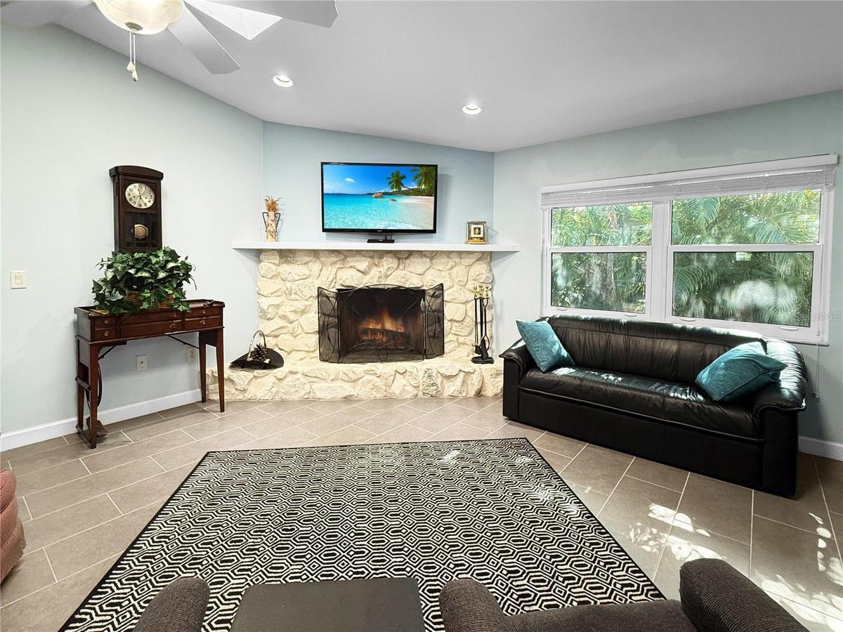 The fireplace is the focal point of the family room, which has a cathedral ceiling, skylights, and impact-resistant windows.