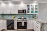 Updated gourmet kitchen with granite featuring waterfall edge