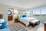 Spacious primary bedroom Suite with a sitting area, built out walk in closet, dresssing area and a tub/shower in bathroom.