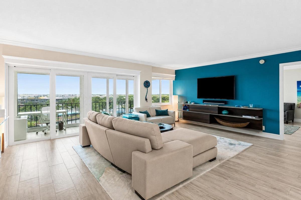 Living room has sliders to a glass enclosed balcony with expansive direct Intracoastal waterway and city views.