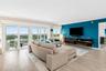 Living room has sliders to a glass enclosed balcony with expansive direct Intracoastal waterway and city views.