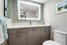 Spacious half bathroom with penny tile back splash, a light up mirror and a medicine cabinet for extra storage.