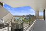 Spacious living area with sliding doors opening to the balcony and water views