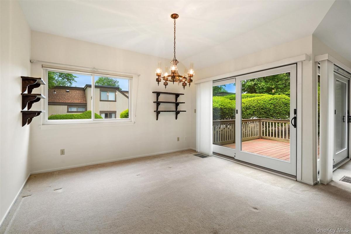 Formal dining room with Andersen slider out to backyard deck