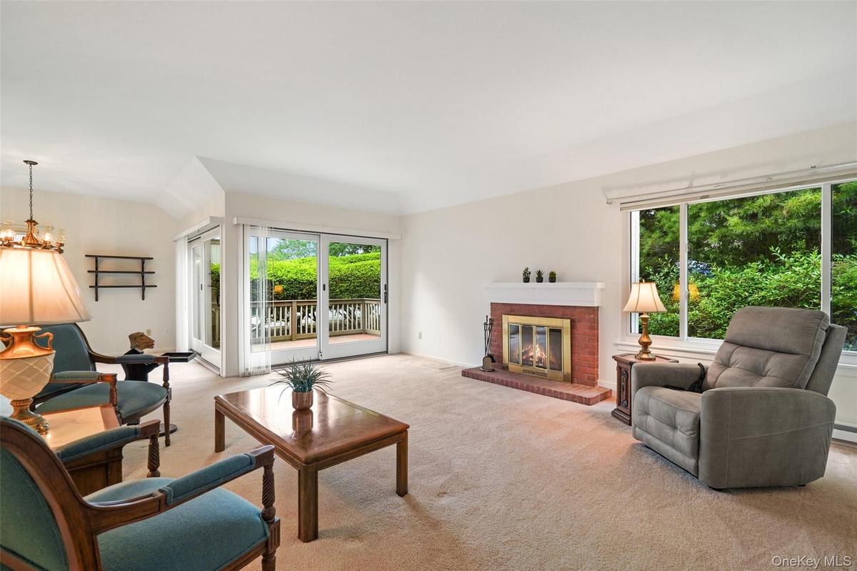 Formal living room with fireplace and Andersen slider out to backyard deck