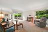 Formal living room with fireplace and Andersen slider out to backyard deck