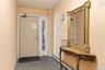 Entry area featuring a solid panel door with sidelight, neutral wall paint, and carpet flooring