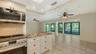 Breakfast bar opens to living and dining spaces.