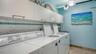 Common laundry room on same floor includes 2 sets of coinless WDs, & owner storage cabinets.