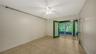 Primary bedroom with French doors leading to private enclosed lanai that runs the length of the unit.