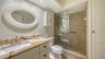 Updated primary bathroom with granite counters, new fixtures, & soft close cabinetry.
