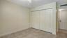 Guest bedroom features two built-in closets.