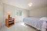 Spacious room featuring light-colored carpeting, a double window, and a flush mount ceiling light fixture