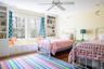 Bedroom featuring visible vents, crown molding, ceiling fan, and wood finished floors