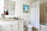 Bathroom featuring vanity, toilet, and tiled shower / bath combo