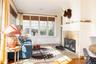 Living room featuring a fireplace, crown molding, and wood finished floors