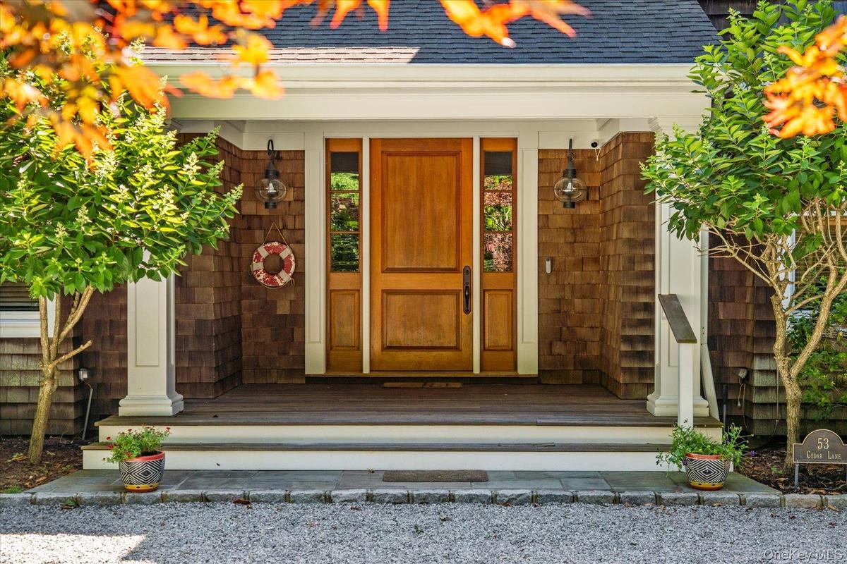 Doorway to property with a shingled roof