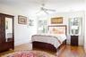 Bedroom with visible vents, ornamental molding, and wood finished floors