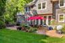 Rear view of property with a balcony, a patio area, and a yard