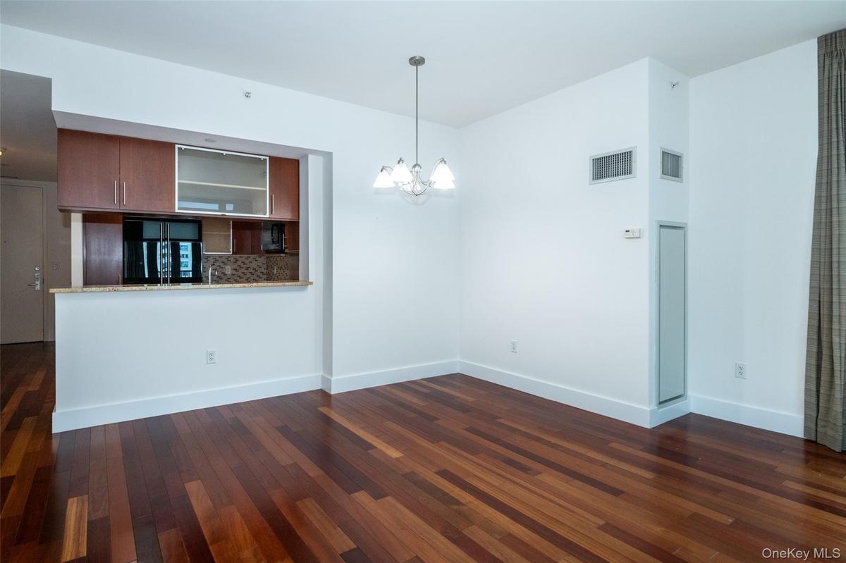 Dining area featuring a chandelier and dark wood finished floors