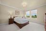 Has a Queen size Bed, carpet and has a walk in closet