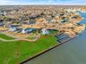 Aerial overview of property's location with property boundaries highlighted and a nearby body of water