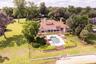 firm. Every detail reflects elegance and grace for the most discerning homeowner. The cultivated beauty of this one-owner home is nestled on a lush, p