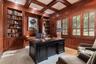 Library/ office with solid CHERRY WOOD lined walls, shutters & coffered ceiling can be used for the 5th bedroom.