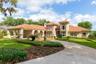 Biltmore GAS LANTERNS, SHUTTERS, BALCONIES & TOWERING tree canopies as you approach this MEDITERRANEAN-RIVIERA style estate.