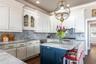 An abundance of cabinetry, storage, island, massive STAINLESS-STEEL appliances, GRANITE prep space & HIGH-END fixtures make this functional as well as