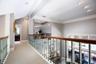Walkway above the first floor that leads to the loft, additional bedroom and bathroom. Private get away space and yet you still feel like you are part
