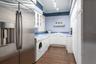 Look at the size of this laundry room! Situated off the corridor of the side entrance.  Equipped with an additional refrigerator, load of cabinetry an