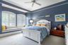 One of the many beautifully designed bedrooms, with lots of light, plantation shutters and even a window seat to enjoy the grounds.