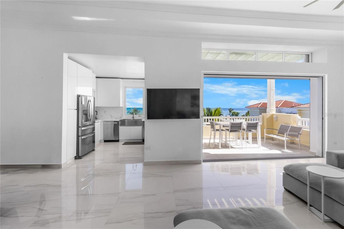 Spacious living room dining room area with sliding doors that hide inside the pocket to give you an indoor/outdoor feeling.