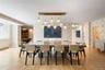 Dining space featuring parquet flooring, patterned wallpaper, and built-in window storage