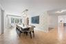 Spacious dining area featuring parquet flooring and a multi-globe chandelier