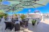 This outdoor oasis overlooks the canal and 16,000-pound boat lift, providing a perfect space to relax and watch the boats drift by.