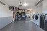 The garage includes a new 2025 washer, 2021 dryer, organized shelving, and plenty of workspace for storage or hobbies.