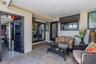 The front patio courtyard offers a peaceful outdoor retreat with brick pavers, a mounted fan, and direct access to both the garage and the second bedr