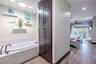 A bright hallway leads from the primary suite toward the main living areas, connecting the private retreat to the open, airy layout of the home.