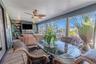 Enjoy the gentle waterfront breeze from the enclosed bonus room, a comfortable spot to unwind with a book or morning coffee.