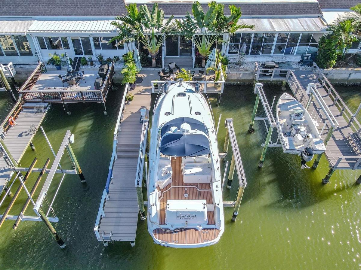 Your private dock includes a 16,000-lb oversized boat lift accommodating up to a 36-ft vessel, 50-amp shore power, and pedestal lighting for evening a