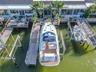 Your private dock includes a 16,000-lb oversized boat lift accommodating up to a 36-ft vessel, 50-amp shore power, and pedestal lighting for evening a