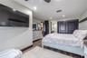 This restful retreat connects seamlessly to the ensuite bathroom, blending modern design with the calm feeling of a private spa.