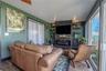 Relax in this inviting seating area surrounded by picture windows that fill the room with natural light and tranquil canal views.
