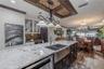 The dual-zone wine and beverage refrigerator provides the ultimate convenience for hosting, complementing the kitchen’s high-end finishes.