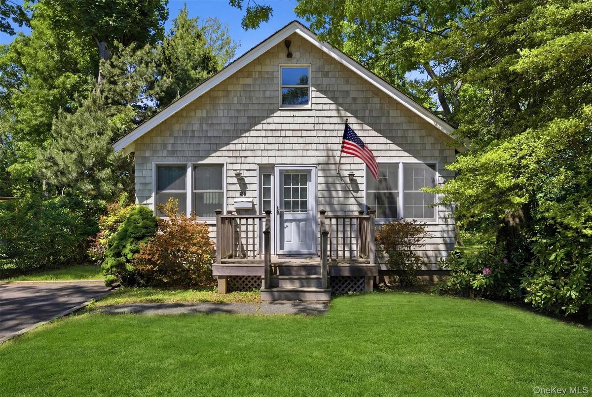 Single-story residence featuring light gray shingle siding