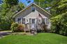 Single-story residence featuring light gray shingle siding